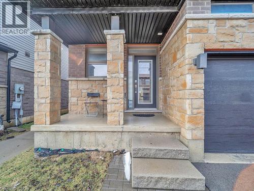 Doorway to property featuring stone siding and a porch - 30 Times Square Boulevard Unit# #177, Hamilton, ON - Outdoor