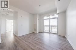 Unfurnished room featuring light wood-style flooring and a textured ceiling - 