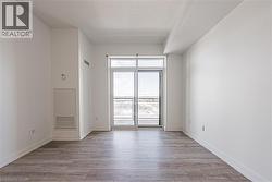 Unfurnished room featuring light wood-type flooring and a textured ceiling - 