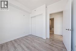Unfurnished bedroom with light wood-type flooring and a closet - 