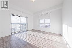Spare room with plenty of natural light and light wood-style floors - 