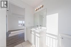 Half bath with vanity and light tile patterned floors - 