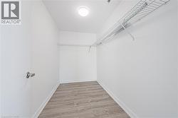 Walk in closet with light wood finished floors - 