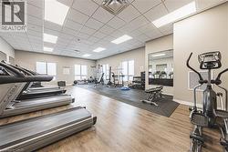 Exercise room featuring a drop ceiling - 