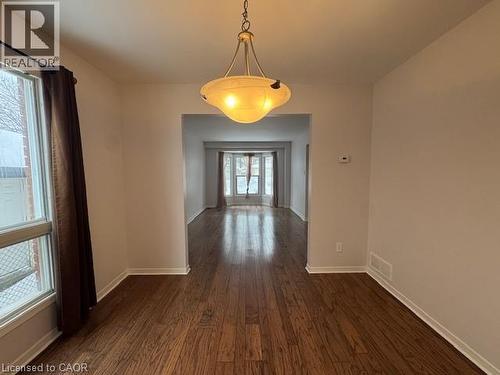 Unfurnished dining area with dark wood-style floors and baseboards - 536 Thorndale Drive, Waterloo, ON - Indoor Photo Showing Other Room