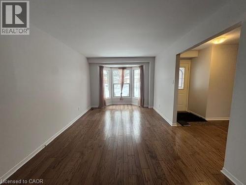 Unfurnished room with baseboards and dark wood finished floors - 536 Thorndale Drive, Waterloo, ON - Indoor Photo Showing Other Room