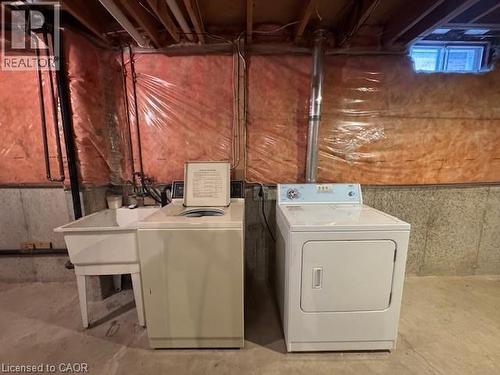 Laundry area featuring unfinished concrete flooring and washing machine and clothes dryer - 536 Thorndale Drive, Waterloo, ON - Indoor Photo Showing Laundry Room