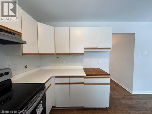 Kitchen featuring stainless steel electric range oven, white cabinets, light countertops, dark wood-type flooring, and tasteful backsplash - 536 Thorndale Drive, Waterloo, ON - Indoor Photo Showing Kitchen