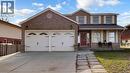 View of front of property with brick siding, an attached garage, a porch, and driveway - 330 Guelph Avenue, Cambridge, ON  - Outdoor With Facade 