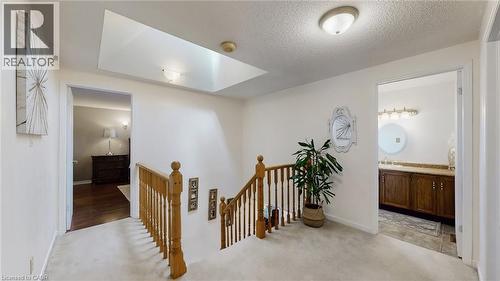 Hall featuring an upstairs landing, light carpet, a skylight, and a textured ceiling - 330 Guelph Avenue, Cambridge, ON - Indoor Photo Showing Other Room