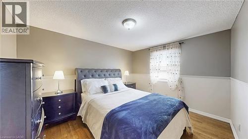 Bedroom featuring wood finished floors and a textured ceiling - 330 Guelph Avenue, Cambridge, ON - Indoor Photo Showing Bedroom