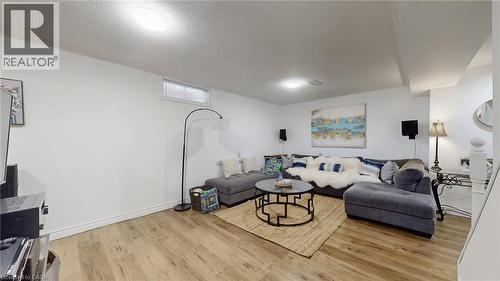 Living room featuring light wood finished floors and a textured ceiling - 330 Guelph Avenue, Cambridge, ON - Indoor Photo Showing Living Room