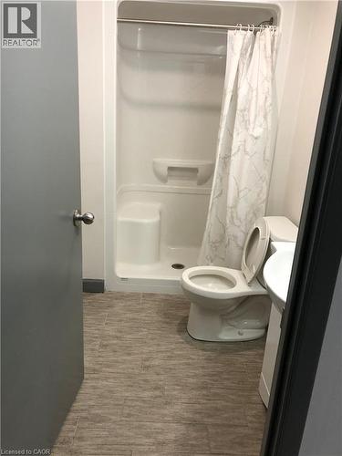 Full bath featuring a shower stall, vanity, and dark wood finished floors - 258 Sunview Street Unit# 225, Waterloo, ON - Indoor Photo Showing Bathroom