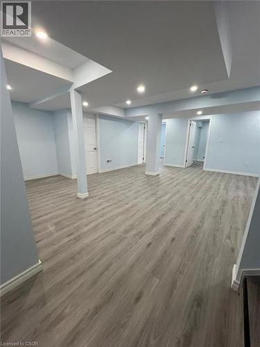 Finished below grade area with dark wood-type flooring and recessed lighting - 167 Histand Trail Unit# Lower, Kitchener, ON - Indoor