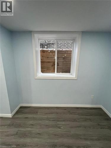 Unfurnished room with baseboards and dark wood-style floors - 167 Histand Trail Unit# Lower, Kitchener, ON - Indoor Photo Showing Other Room
