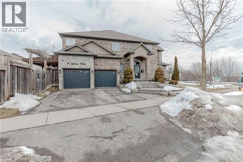 French provincial home featuring brick siding, asphalt driveway, and a garage - 2 Doon Creek Street, Kitchener, ON - Outdoor With Facade