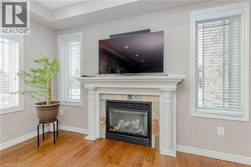 Detailed view of wood finished floors and a premium fireplace - 2 Doon Creek Street, Kitchener, ON - Indoor Photo Showing Living Room With Fireplace