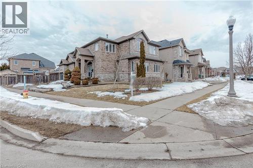 View of front facade featuring a residential view, stone siding, and brick siding - 2 Doon Creek Street, Kitchener, ON - Outdoor With Facade