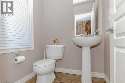 Half bath with toilet and tile patterned flooring - 2 Doon Creek Street, Kitchener, ON - Indoor Photo Showing Bathroom