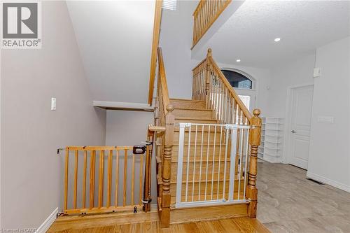 Stairway with wood finished floors and recessed lighting - 2 Doon Creek Street, Kitchener, ON - Indoor Photo Showing Other Room