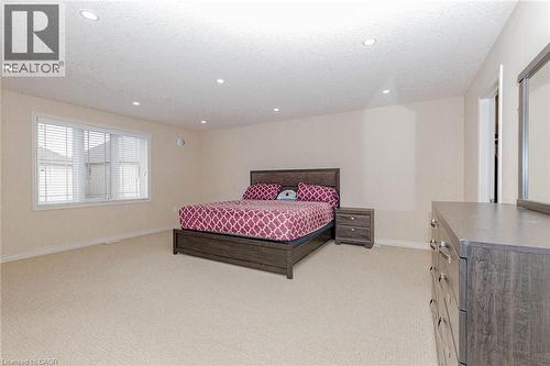 Bedroom with light colored carpet, recessed lighting, and a textured ceiling - 2 Doon Creek Street, Kitchener, ON - Indoor Photo Showing Bedroom
