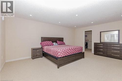 Bedroom featuring a spacious closet, light carpet, recessed lighting, and a textured ceiling - 2 Doon Creek Street, Kitchener, ON - Indoor Photo Showing Bedroom
