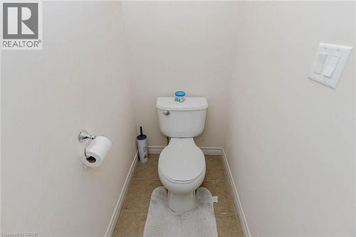 Bathroom featuring toilet and light tile patterned floors - 2 Doon Creek Street, Kitchener, ON - Indoor Photo Showing Bathroom