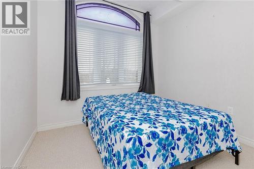 Bedroom with light colored carpet and multiple windows - 2 Doon Creek Street, Kitchener, ON - Indoor Photo Showing Bedroom