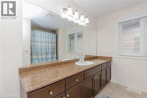 Full bathroom featuring vanity, a shower with shower curtain, and light tile patterned floors - 2 Doon Creek Street, Kitchener, ON - Indoor Photo Showing Bathroom
