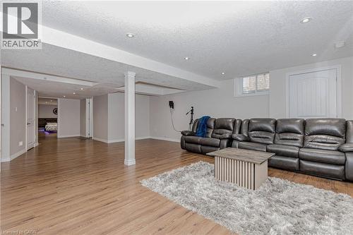Living area featuring light wood-style floors, a textured ceiling, and recessed lighting - 2 Doon Creek Street, Kitchener, ON - Indoor Photo Showing Living Room
