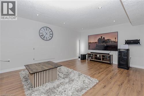 Living room with light wood-style floors and a textured ceiling - 2 Doon Creek Street, Kitchener, ON - Indoor Photo Showing Living Room