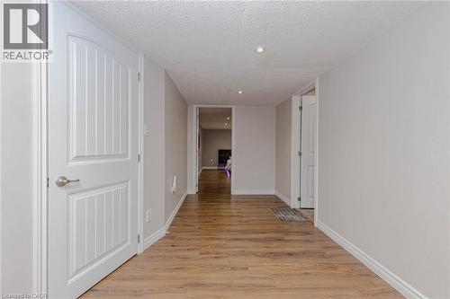 Corridor featuring light wood-type flooring, a textured ceiling, and recessed lighting - 2 Doon Creek Street, Kitchener, ON - Indoor Photo Showing Other Room