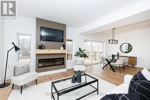 Living room opens into dining area - 1129 Dipietro Street, Fort Erie (Lakeshore), ON - Indoor Photo Showing Living Room With Fireplace