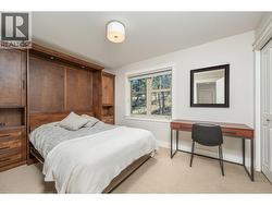 Comfort for your guests in this Multi-functional 2nd bedroom with space-saving Murphy bed unit with blt-in cabinetry and shelving. - 
