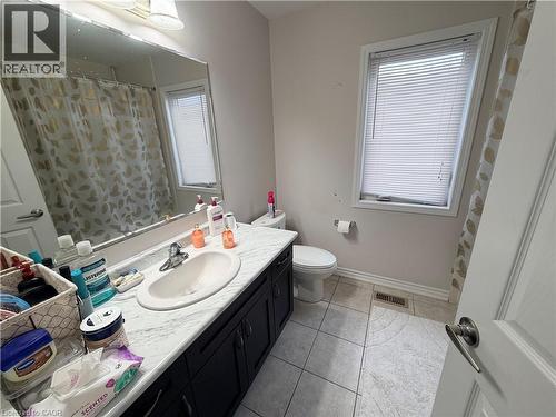 Full bathroom featuring vanity, light tile patterned floors, and a shower with shower curtain - 31 Sofitel Drive, Kitchener, ON - Indoor Photo Showing Bathroom