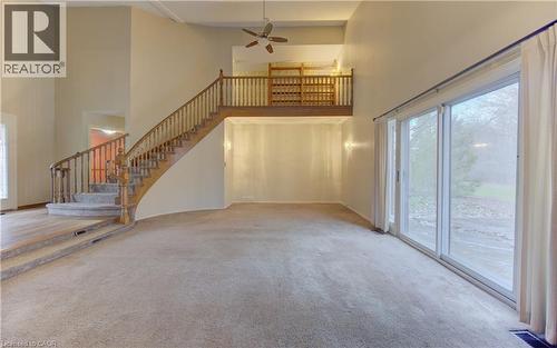 Unfurnished living room with ceiling fan, light colored carpet, and a high ceiling - 190 Silvercrest Drive, Waterloo, ON - Indoor Photo Showing Other Room