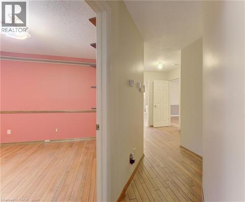 Hallway with light wood-style flooring and a textured ceiling - 190 Silvercrest Drive, Waterloo, ON - Indoor Photo Showing Other Room