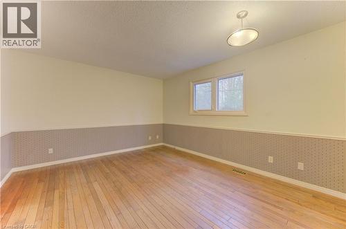 Unfurnished room with wallpapered walls, a wainscoted wall, and light wood-style floors - 190 Silvercrest Drive, Waterloo, ON - Indoor Photo Showing Other Room