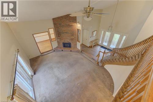 Unfurnished living room with ceiling fan, a fireplace, vaulted ceiling, and french doors - 190 Silvercrest Drive, Waterloo, ON - Indoor Photo Showing Other Room