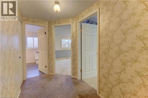 Corridor with a textured ceiling, plenty of natural light, and light carpet - 190 Silvercrest Drive, Waterloo, ON - Indoor Photo Showing Other Room