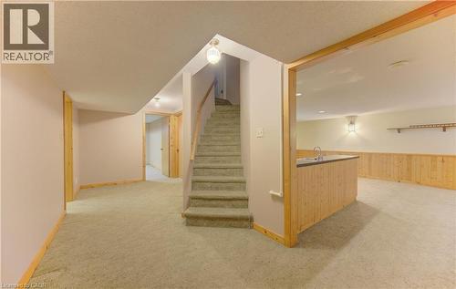 Stairs with carpet, a wainscoted wall, and wood walls - 190 Silvercrest Drive, Waterloo, ON - Indoor Photo Showing Other Room