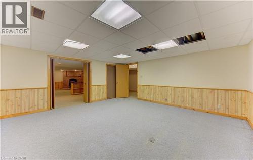 Spare room with a paneled ceiling, light colored carpet, and a brick fireplace - 190 Silvercrest Drive, Waterloo, ON - Indoor Photo Showing Other Room