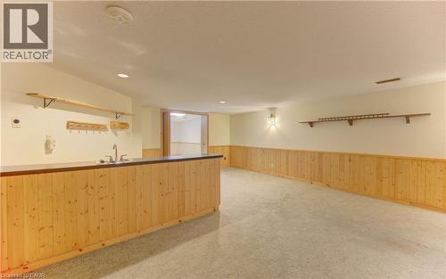 Kitchen featuring light colored carpet, open shelves, wood walls, light wood finish cabinets, and wainscoting - 190 Silvercrest Drive, Waterloo, ON - Indoor
