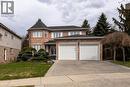 Traditional-style house featuring brick siding, a garage, a front lawn, and driveway - 54 Woodcrest Court, Kitchener, ON  - Outdoor With Facade 