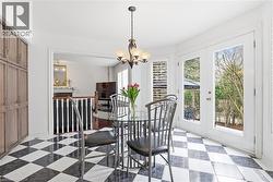 Dining area with french doors, light flooring, and hanging lights - 