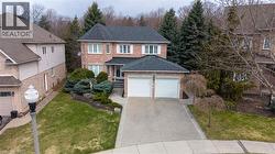 Traditional-style home with a front lawn, brick siding, and driveway - 
