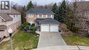 Traditional-style home with a front lawn, brick siding, and driveway - 54 Woodcrest Court, Kitchener, ON  - Outdoor 