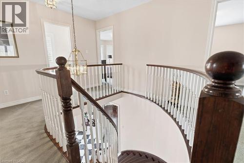 Stairs featuring suspended lighting and carpet floors - 54 Woodcrest Court, Kitchener, ON - Indoor Photo Showing Other Room