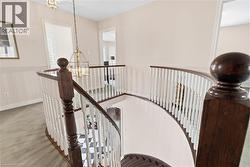 Stairs featuring suspended lighting and carpet floors - 