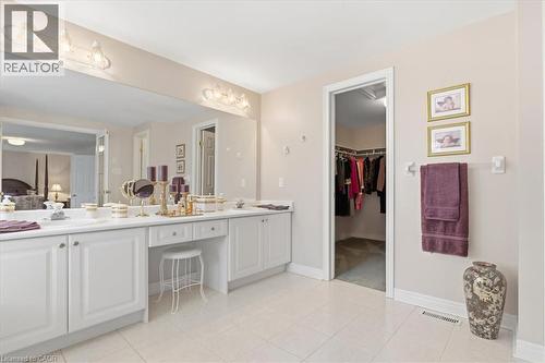 Ensuite bathroom featuring double vanity, a walk in closet, and light tile patterned floors - 54 Woodcrest Court, Kitchener, ON - Indoor Photo Showing Bathroom